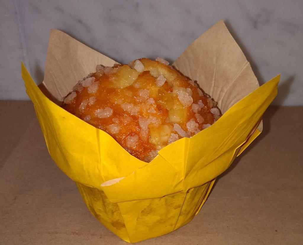 Lemon Muffin · Made with lemon puree and fresh lemon bits finished with a pearl sugar topping