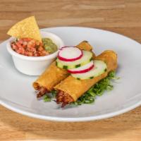 Taquitos Veracruz · Corn tortillas filled with choice of shredded chicken or beef with lettuce, guacamole, sour ...