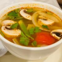 15. Tom Yum Soup · Spicy sour lemongrass soup with lime leaves, galangal, mushrooms, onions, bell peppers and c...