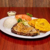 Bistec Encebollado · Checkmark. Steak with onions and tomatoes.