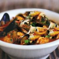 Zuppa Di Pesce · Fish soup with mussels, clams, scallops, calamari, and shrimp in a light tomato sauce with p...