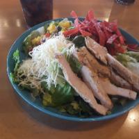 Habanero Salad · A large bowl of crisp lettuce, black beans, cilantro lime rice and grilled chicken fajita. T...