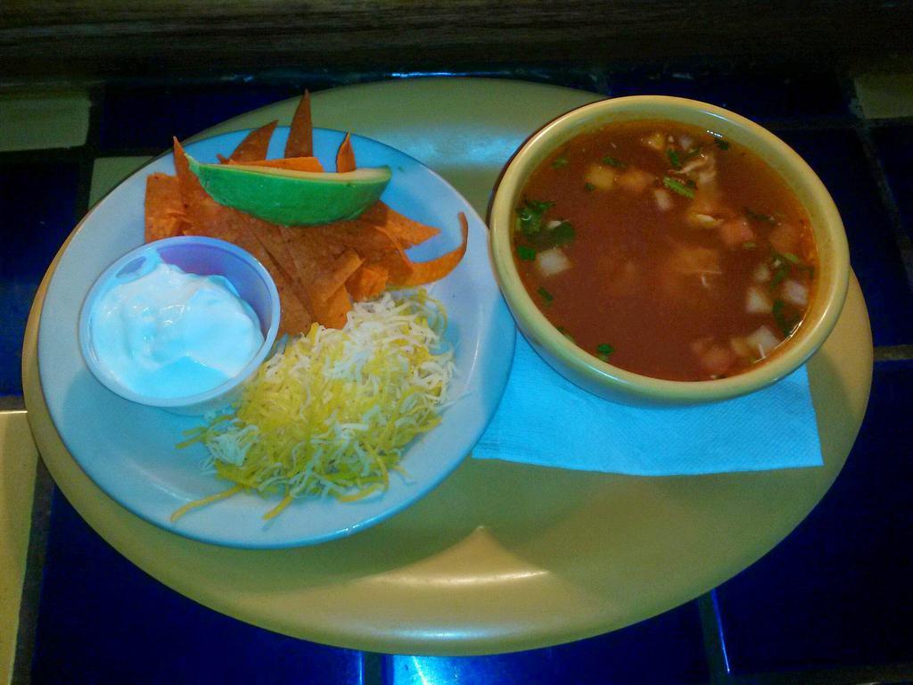 Chicken Tortilla Soup · Our large bowl of chicken tortilla soup is loaded with shredded chicken, onions, tomatoes, and jalapenos. Served with fried crispy tortilla strips, cheese, sour cream and avocado slices.