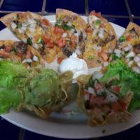 Fajita Nachos · Traditional nachos topped with either fajita steak or chicken, melted cheese and pico de gal...