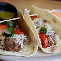 Brisket Taco Platter · Slow cooked brisket tacos topped with grilled onions, poblano peppers and Jack cheese. Serve...