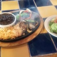 Baja Fajitas · A sizzling skillet of marinated chicken or combination inside skirt steak and chicken, saute...