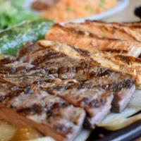 Baja Fajitas for 2 · A sizzling skillet of marinated chicken or combination inside skirt steak and chicken, saute...