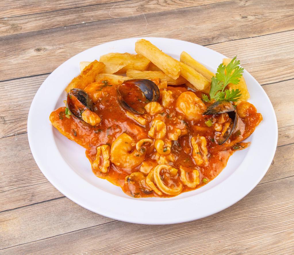 Pescado a Lo Macho · Fried fish fillet covered with seafood sauce served with potatoes. Pescado y mariscos.