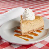 Pumpkin Cheesecake · Pumpkin cheesecake with cinnamon sugar cookie crust. Topped with whipped cream and garnished...