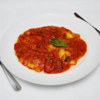 I’Nostri Ravioli di Ricotta e Spinaci · Homemade ravioli with spinach, ricotta and tomato sauce.