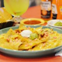 Super Nachos · No meat. corn tortilla deep-fried until crispy golden and topped with beans, melted cheese, ...