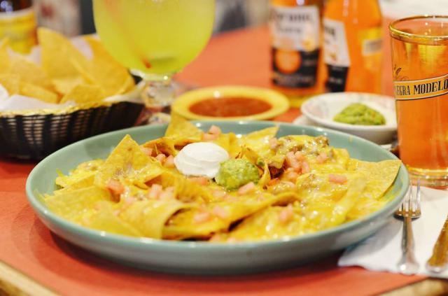 Super Nachos · No meat. corn tortilla deep-fried until crispy golden and topped with beans, melted cheese, freshly chopped tomato, guacamole and sour cream.
