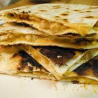 Quesadilla · Soft flour tortilla stuffed with melted cheese. Served with guacamole and sour cream.