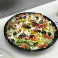 Mediterranean Salad · Fresh greens with red onions, roasted red peppers, black olives, tomatoes and banana peppers...