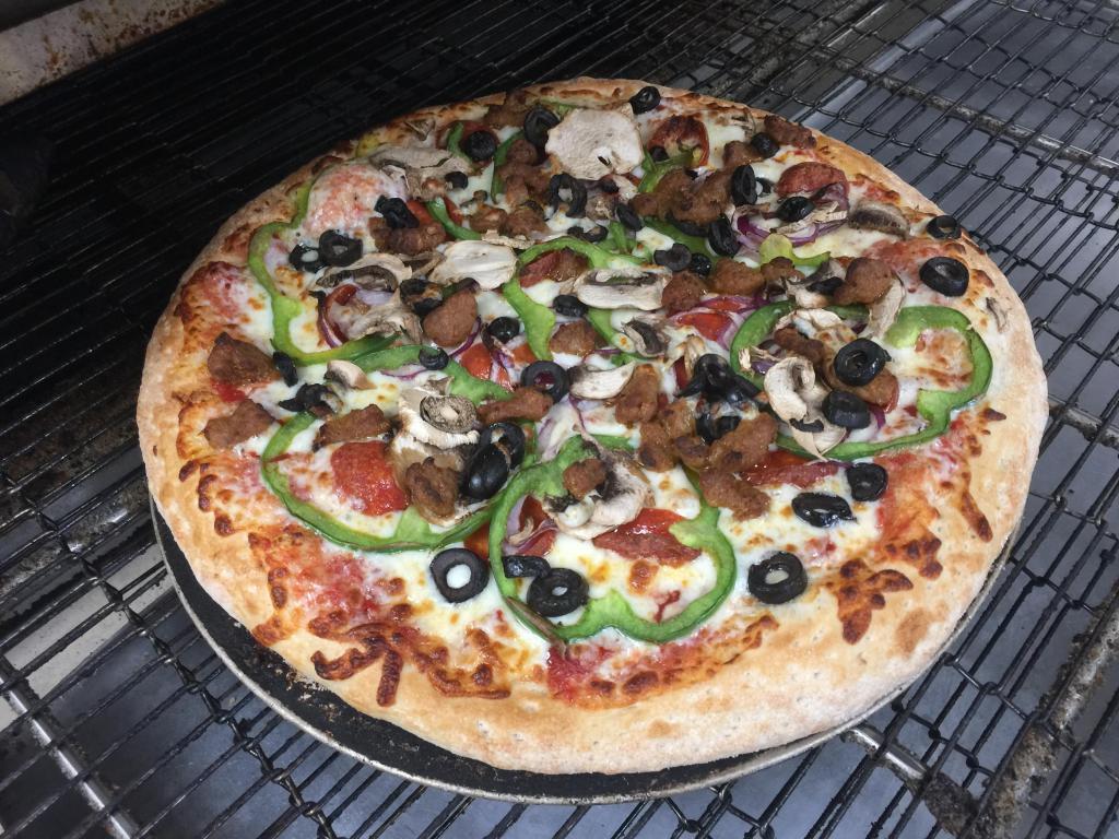 Deluxe Pizza · Traditional red pizza sauce, pepperoni, mushrooms, green peppers, red onions, black olives, Italian sausage and mozzarella cheese.