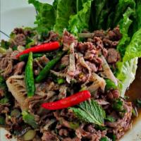 24. Larb Salad · Ground chicken, beef, or pork, mixed in ground roasted rice, chili, lime juice, onions, scal...
