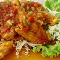 60. Sweet and Sour Fish · Crispy whole fish Tilapia, fried to perfection, topped with bell peppers, tomatoes, onion, p...