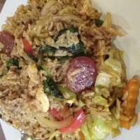 63. Spicy Fried Rice · Thai style spicy fried rice with sauteed chili, tomatoes, onions, bell peppers, eggs and bas...