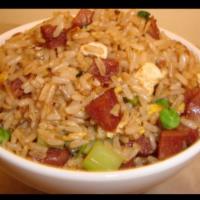 65. Sausage Fried Rice · Fried rice with Chinese sausage, green onions, carrots, green peas, onions, garlic and eggs.
