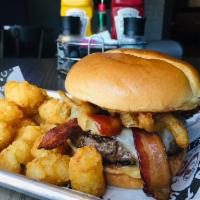 Saints Burger · 8 oz beef patty, pepper-jack cheese, bacon, onion tanglers, BBQ sauce, brioche bun. Our sign...