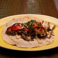 Pork Pibil Taco · Smoked pulled pork, char-grilled onion and red peppers, cilantro and topped with chipotle ai...