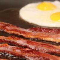 Thick Cut Smoked Bacon and Eggs · Served with Hash Browns or Homestyle Potatoes and either a buttermilk biscuit, toast, bluebe...