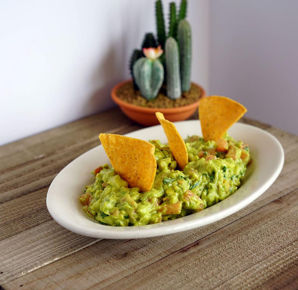 Guacamole · Fresh chopped tomatoes, onions, avocado, cilantro, and lime juice with fresh corn tortilla chips.