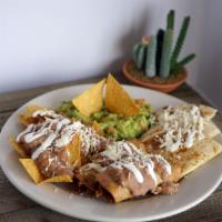 Mexican Trio · Combination of nachos con queso, guacamole, flautas, and cheese quesadilla.