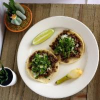 Steak Taco · Fresh steak marinated in our special blend sauce. Soft corn tortilla topped with chopped cil...