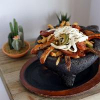 Carnes al Molcajete Special · Marinated beef steak, grilled chicken, hot and spicy pork, and chorizo with sauteed onions a...