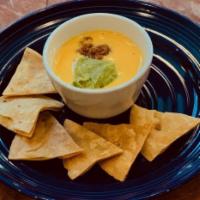 Katie's T-Sip Dip Small · House made chile con queso topped with guacamole and taco meat.