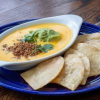 Katie's T-Sip Dip Large · House made chile con queso topped with guacamole and taco meat.
