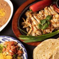 1 lb Chicken Fajitas · Our Grilled Chicken Fajitas. Served with homemade tortillas, Mexican Rice, and Choice of Bea...
