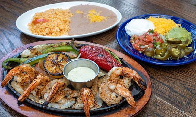 Large Shrimp Fajitas · Twelve jumbo grilled shrimp. Served with homemade tortillas, Mexican Rice, and Choice of Beans.