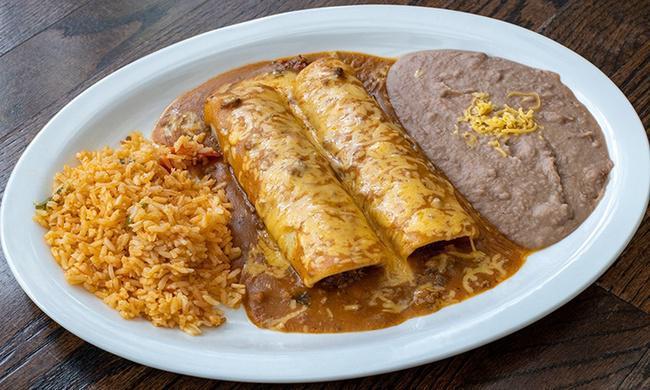 Beef Enchilada Dinner · Two ground beef enchiladas topped with chili gravy and melted cheese. Served with refried beans and Mexican rice.