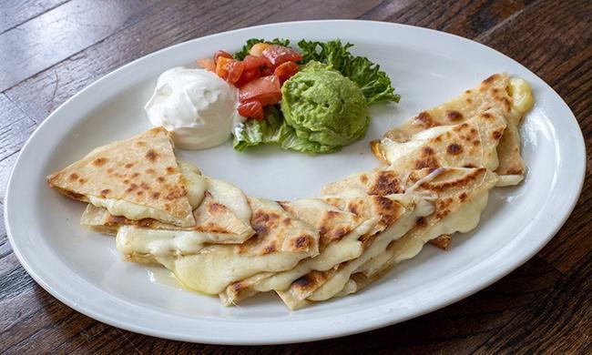 Cheese Quesadilla · Cheese Quesadillas made with homemade tortillas and melted cheese. Served with diced tomatoes, guacamole, and sour cream.