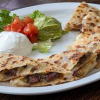 Beef Quesadilla · Grilled Angus Beef Quesadillas made with homemade tortillas and melted cheese. Served with d...