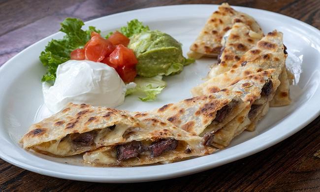 Beef Quesadilla · Grilled Angus Beef Quesadillas made with homemade tortillas and melted cheese. Served with diced tomatoes, guacamole, and sour cream.