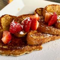French Toast Egg Breakfast · Four slices of french toast topped with strawberries, Two Eggs, Bacon or Sausage