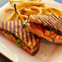 Salmon Sandwich · Wheat bread, smoked salmon, sliced tomatoes, garlic aioli and mixed greens.