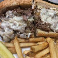 Philly-Style Cheesesteak  · Thinly sliced, choice strip steak with sauteed onions and provolone cheese. Served on a toas...