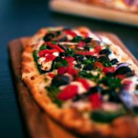 Veggie Flatbread Pizza · Basil pesto, mozzarella, Parmesan-Romano cheese, red bell peppers, red onions, crimini mushr...