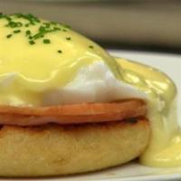 Traditional Eggs Benedict · Canadian bacon. Poached eggs on toasted English muffin and topped with hollandaise sauce.