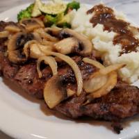Rib Eye Steak · Prime cut steak topped with grilled mushrooms & onions, served with mashed potatoes and mixe...
