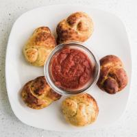 Garlic Knots · 4 pieces and includes 1 dipping sauce.