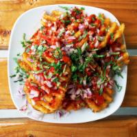 Curry Waffle Fries · Crispy Masala Waffle Fries smothered in Curry Sauce and topped with onion and cilantro