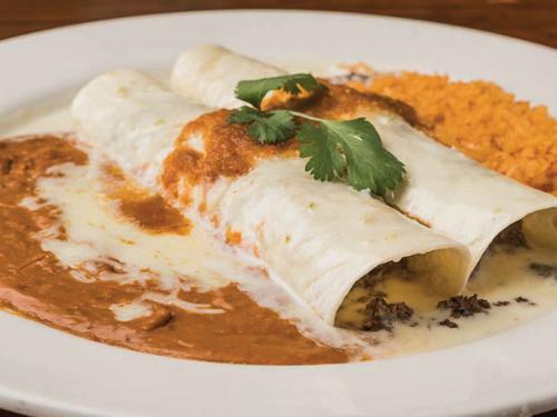 Dos Amigos Burrito · 2 ground beef burritos topped with salsa ranchera and queso blanco. Served with Mexican rice and beans.