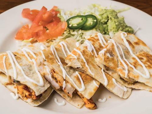 Coyote Fajita Quesadilla · Flour tortilla filled with cheese, grilled steak, chicken, or shrimp. Served with lettuce, tomato, sour cream and guacamole. Add grilled veggies for an additional charge.