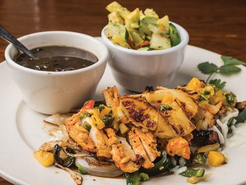 Pollo Tropical · Flame grilled lemon and pepper chicken breast, sauteed poblano peppers, mushrooms, onions, pineapple and Mexican cheese, topped in a mango and roasted chile de arbol tomatillo salsa.