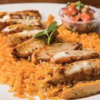 Huasteco · Choose seasoned grilled chicken, steak or shrimp, served over a bed of rice, topped with que...